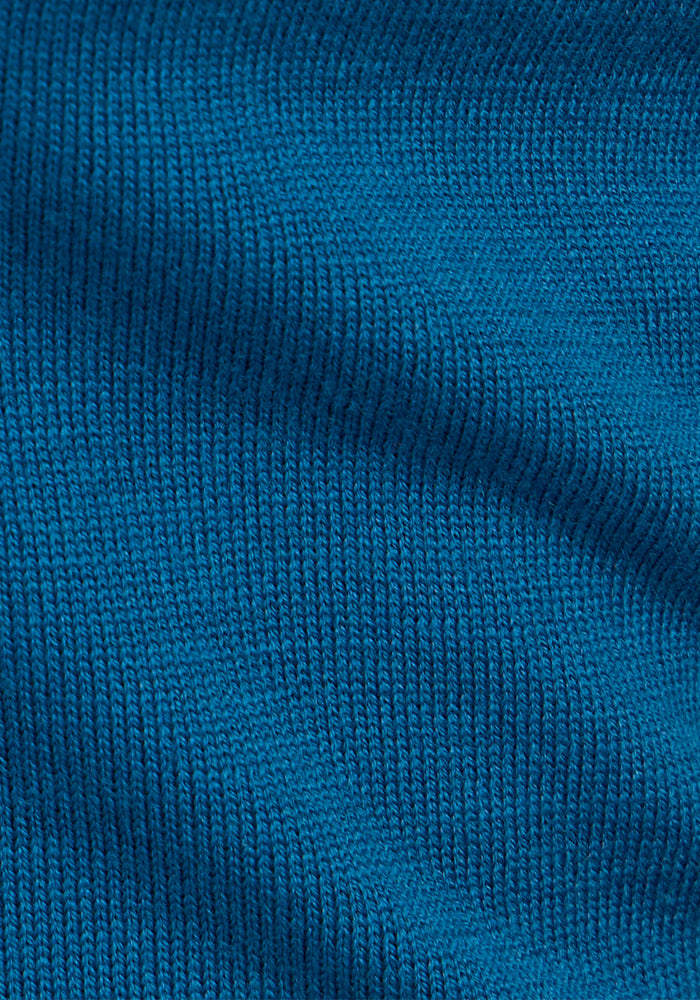 Close-up of the Anna Crew Sweater by Woolx in Moroccan Blue, featuring fine, even stitches and soft merino wool texture that highlights its flexibility and comfort.