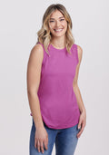 Smiling woman in the Woolx Bella Tunic Top in Purple Wine, final sale, styled with blue jeans and a high neckline.