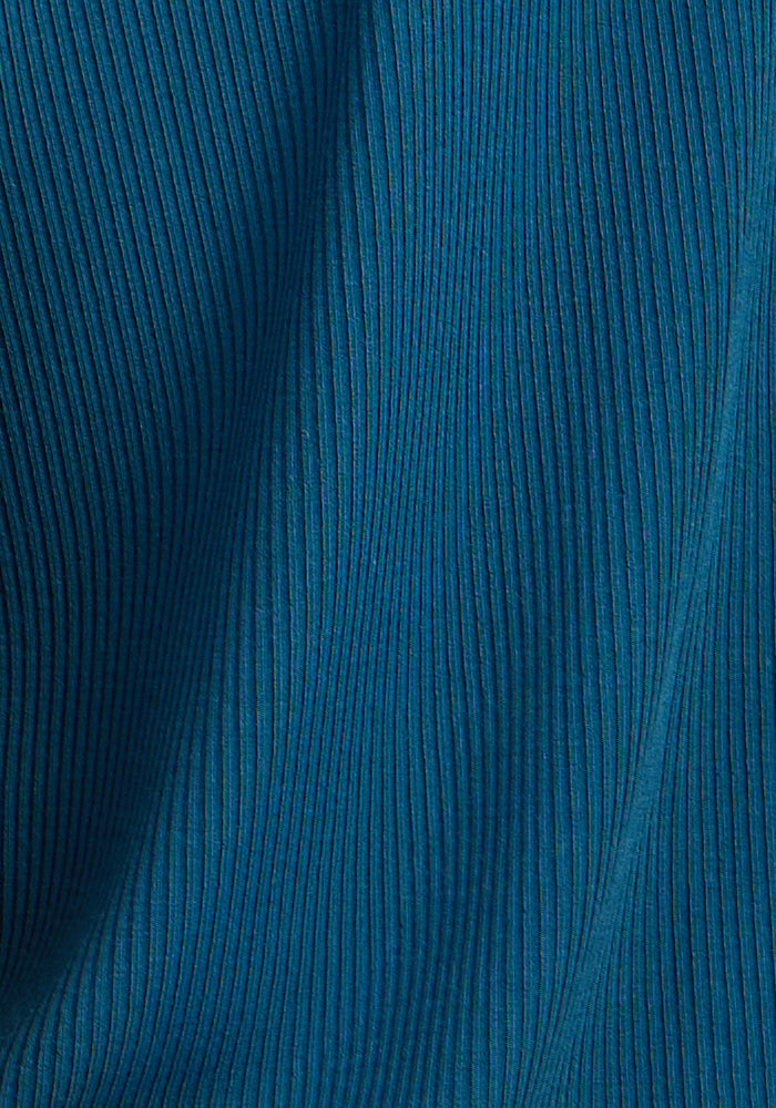 Close-up of Woolx Delia Ribbed Short Sleeve in Moroccan Blue, featuring vertical textured lines and gentle folds.