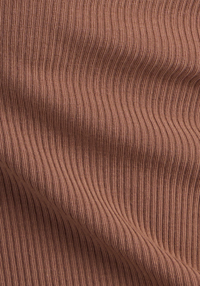 The Woolx Delia Ribbed Short Sleeve in Sienna Kiss features soft fabric with vertical stripes and flowing folds.