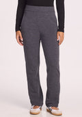 A person wearing Woolx Emerson Straight Leg Pants Petite in Cinder Melange, a long-sleeve black top, and white sneakers stands facing the camera against a plain light background with hands relaxed by their sides.