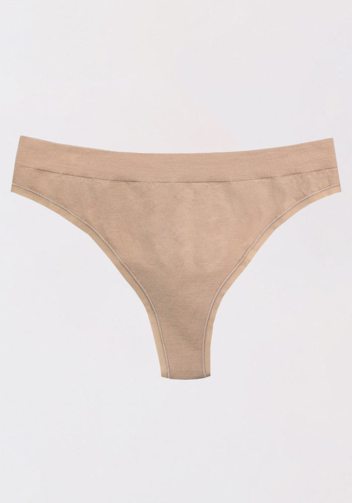 The Woolx Farrah Thong in Sand, crafted from moisture-wicking fabric, is displayed laid flat against a plain white background.