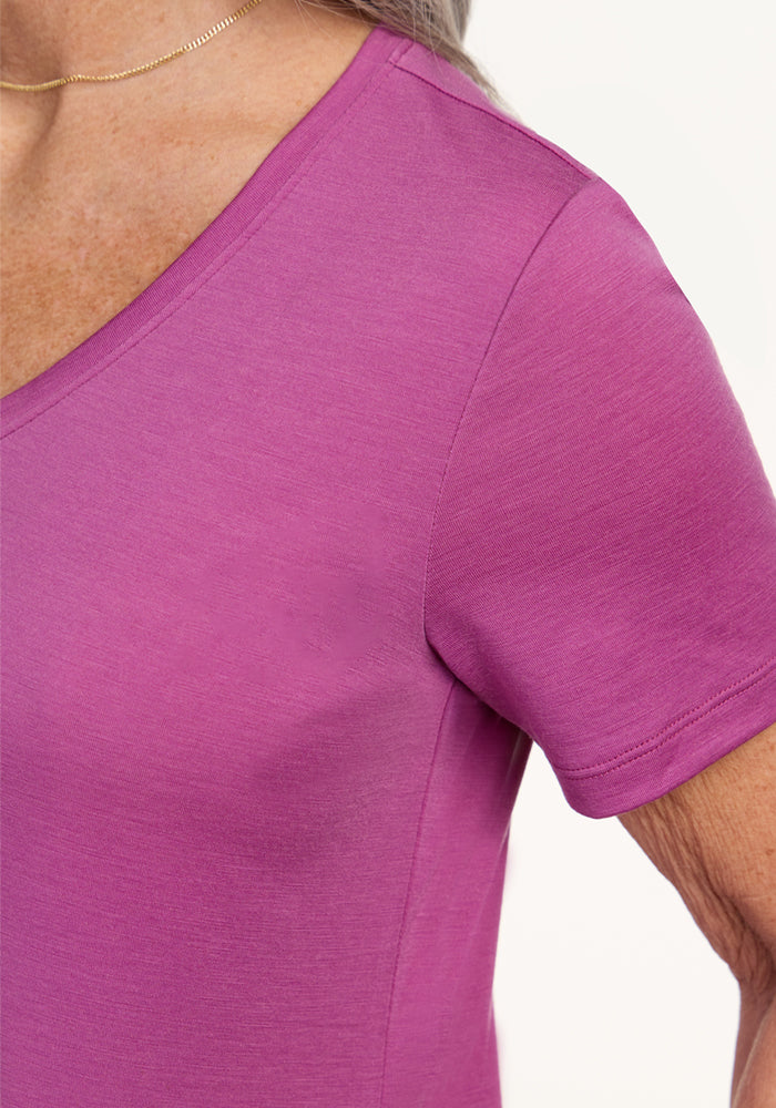 Close-up of a person wearing the Woolx Junie V Neck in Purple Wine, paired with a thin gold necklace.