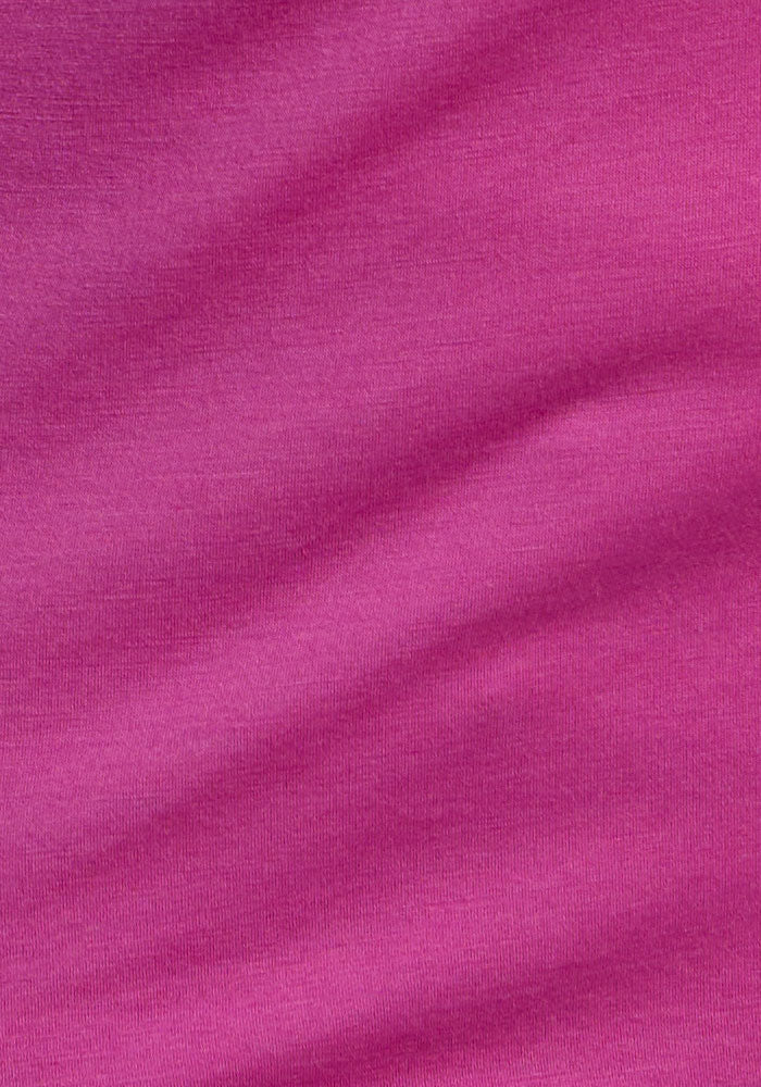Close-up of the Junie V Neck in Summer Sorbet by Woolx, showing pink merino wool texture and soft, wavy folds.