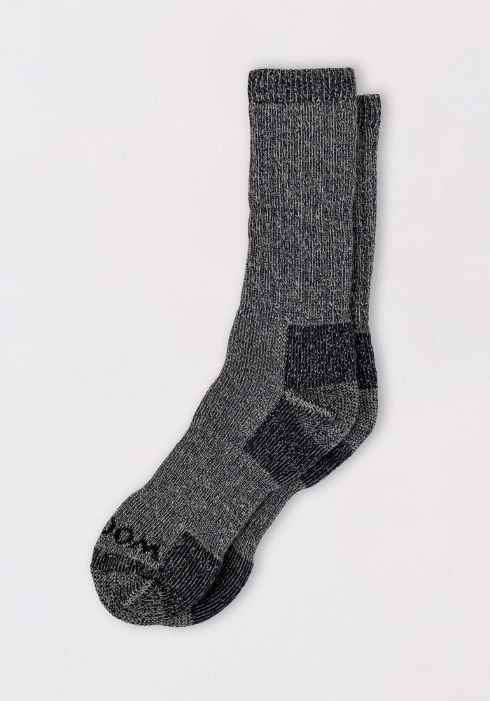 A pair of Woolx Mens Extreme Crew Socks in Charcoal Heather, featuring a ribbed texture and reinforced heel and toe, laid flat on a light background.