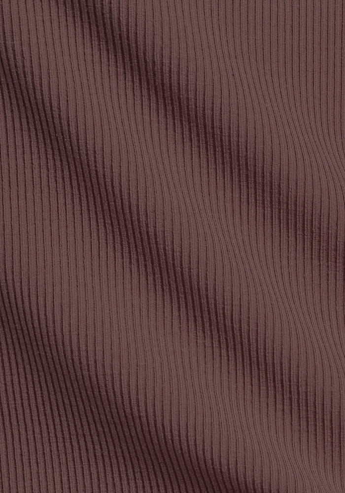 Close-up of ribbed brown fabric, like that in Woolx Miley Bike Shorts - Peppercorn, with vertical textured lines.