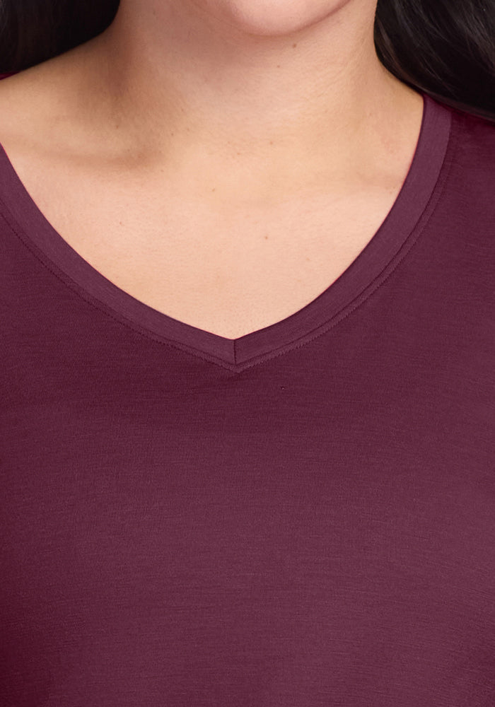 Close-up of a person wearing the Woolx Millie Long Sleeve in Grape Harvest; only neck and collarbone are visible.