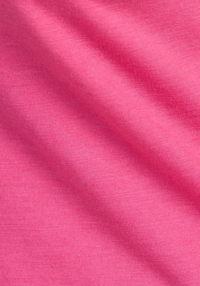 Close-up of Woolx Millie Long Sleeve in Raspberry Fizz, showing fine merino texture and moisture-wicking folds.