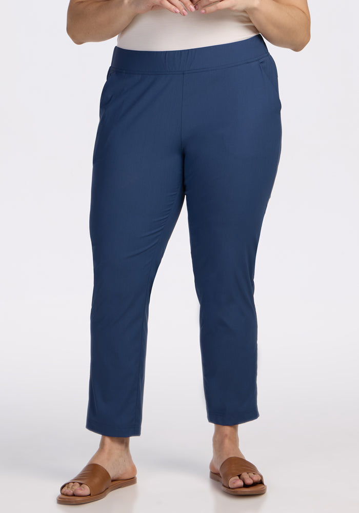 A person models the Woolx Nicole Ankle Pants in Vintage Indigo with brown slide sandals against a white background, showing only the lower half of their body. | Juliana is 5'10", wearing a size XL