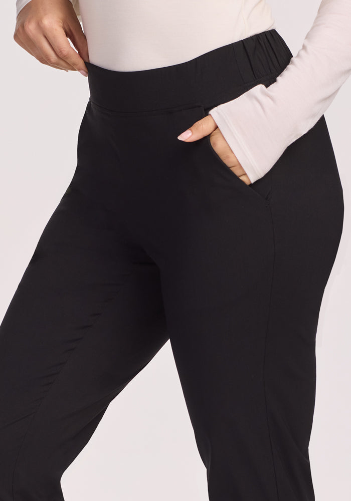 A person wearing Woolx Nicole Petite Ankle Pant in black.