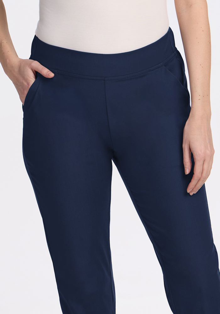 A person models the Woolx Nicole Petite Ankle Pant in Deep Navy, shown from waist to mid-thigh with hands in pockets against a plain background.