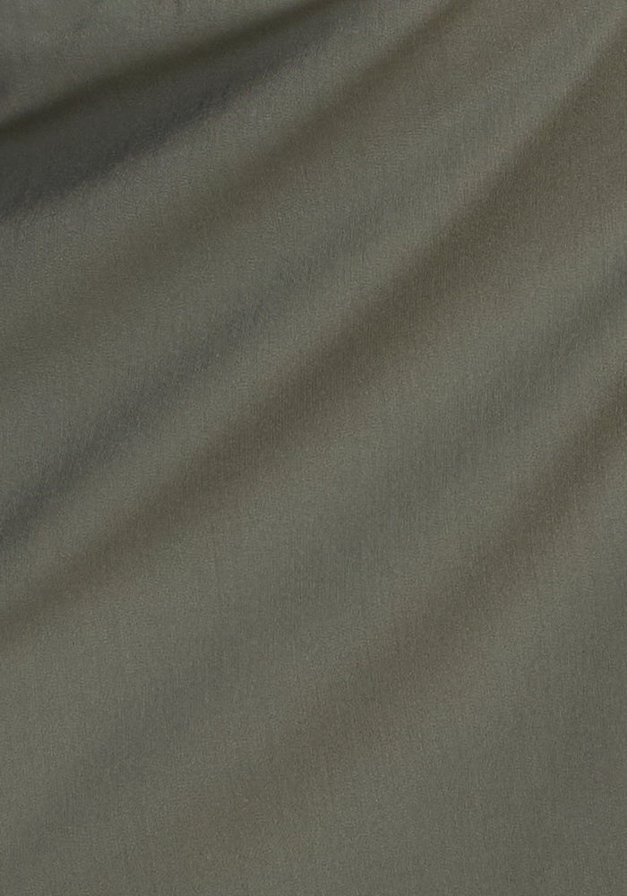 Close-up of the Woolx Nicole Petite Ankle Pant in Sage Olive, highlighting its smooth, breathable fabric with gentle folds—ideal for stylish, comfortable women's petite-length pants.