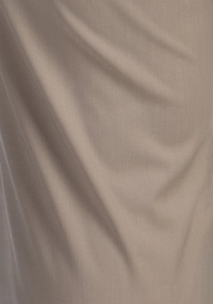 A close-up of the Woolx Nicole Petite Ankle Pant in Vintage Khaki shows soft merino wool with gentle folds and creases, highlighting its subtle texture and shadows.