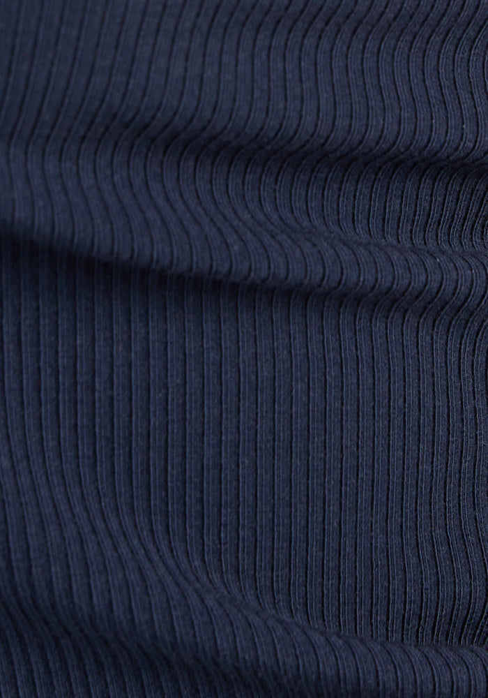 Close-up of Woolx Raegan Ribbed Tank Top in Deep Navy shows vertical textured lines and gentle wool waves.