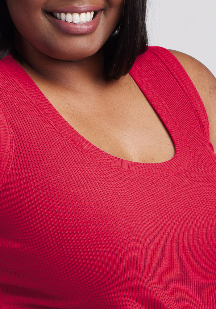 Close-up of a smiling woman wearing the Woolx Sloane Ribbed Tank in Poppy Spark. Final Sale.