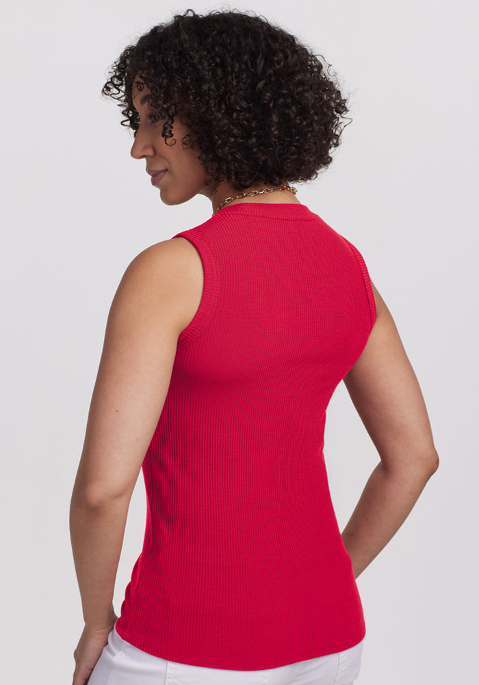 Woman with curly hair in Woolx Sloane Ribbed Tank in Poppy Spark, shown from the back against a plain background.