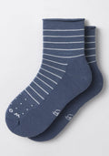 The Woolx Womens Derby Roll Top Sock in Vintage Indigo features white horizontal stripes and dotted toes, displayed on a plain light background. These lightweight, comfortable socks are ideal for everyday wear.