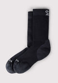 The Woolx Womens Harbor Crew Sock in black features slightly darker heels and toes plus a small white embroidered detail near the top. These moisture-wicking Merino wool crew socks are displayed neatly on a light gray background.