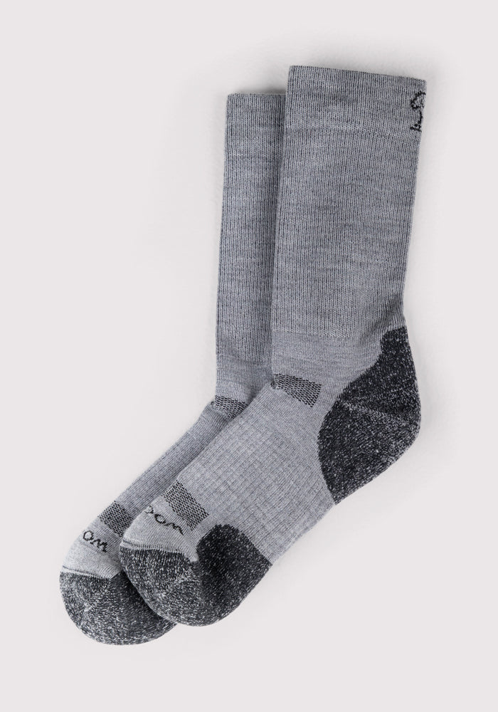 The Woolx Womens Harbor Crew Sock in grey, shown side by side on a light background, features moisture-wicking fabric and dark gray reinforced heels, toes, and soles.