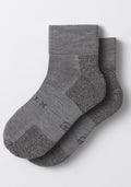 The Woolx Womens Rambler Ankle Sock in Pebble, crafted from Merino wool with ribbed cuffs and textured knit for moisture management, is shown laid flat on a white background.